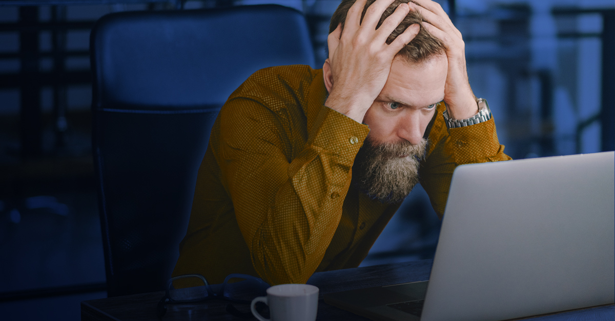 man frustrated by laptop